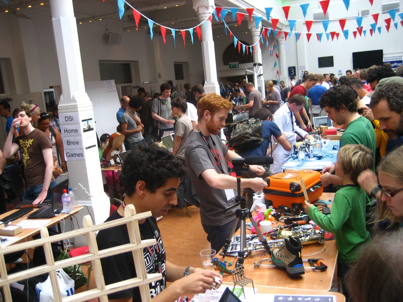 A packed exhibition hall at a maker faire